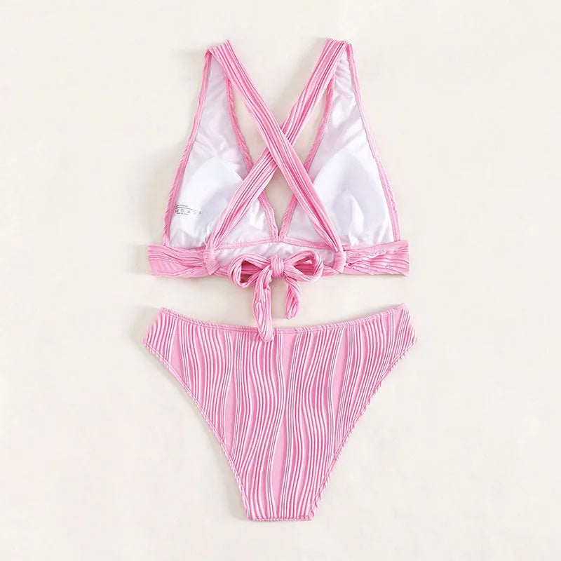 Pink and black women's halter neck bikini set with swim shorts on a mannequin.