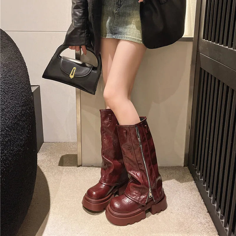 Black platform muffin pants Martin boots with a square heel and knee-high design on a white background.
