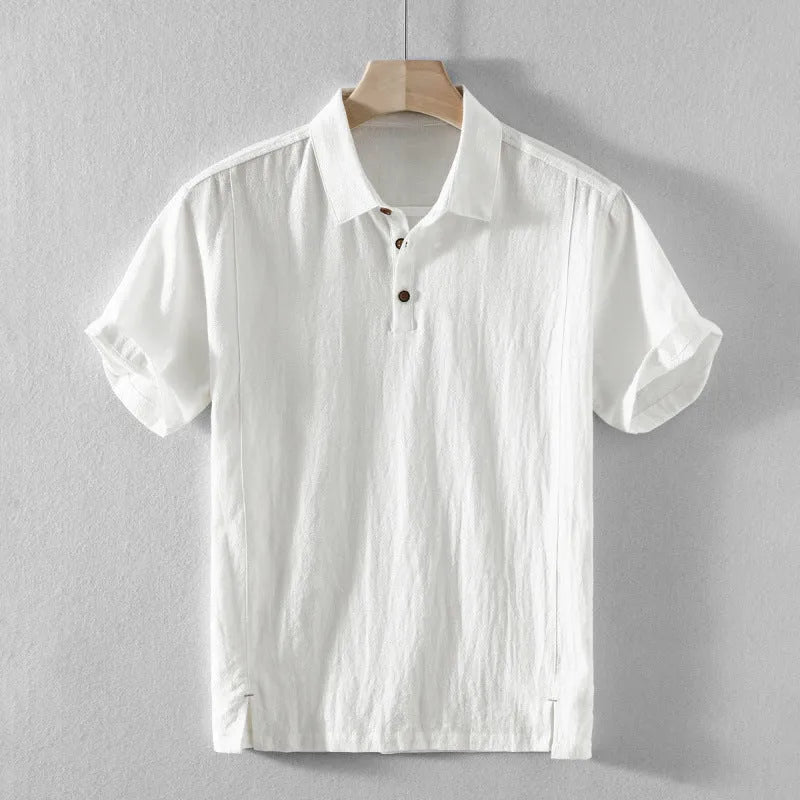 Man wearing a loose-fit light-coloured linen blend casual short-sleeve shirt.