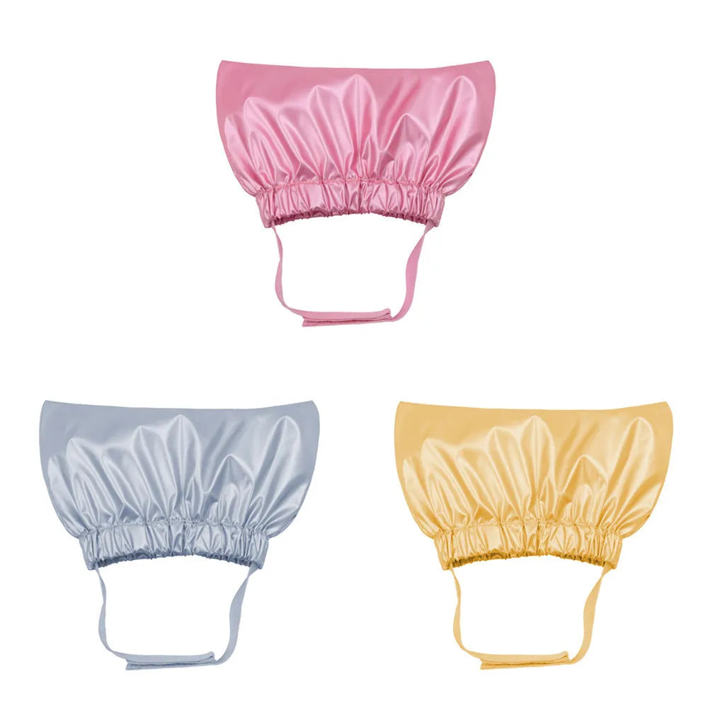 Adjustable ear-proof pet shower cap in non-woven fabric, shown in gold, pink, and silver colours.
