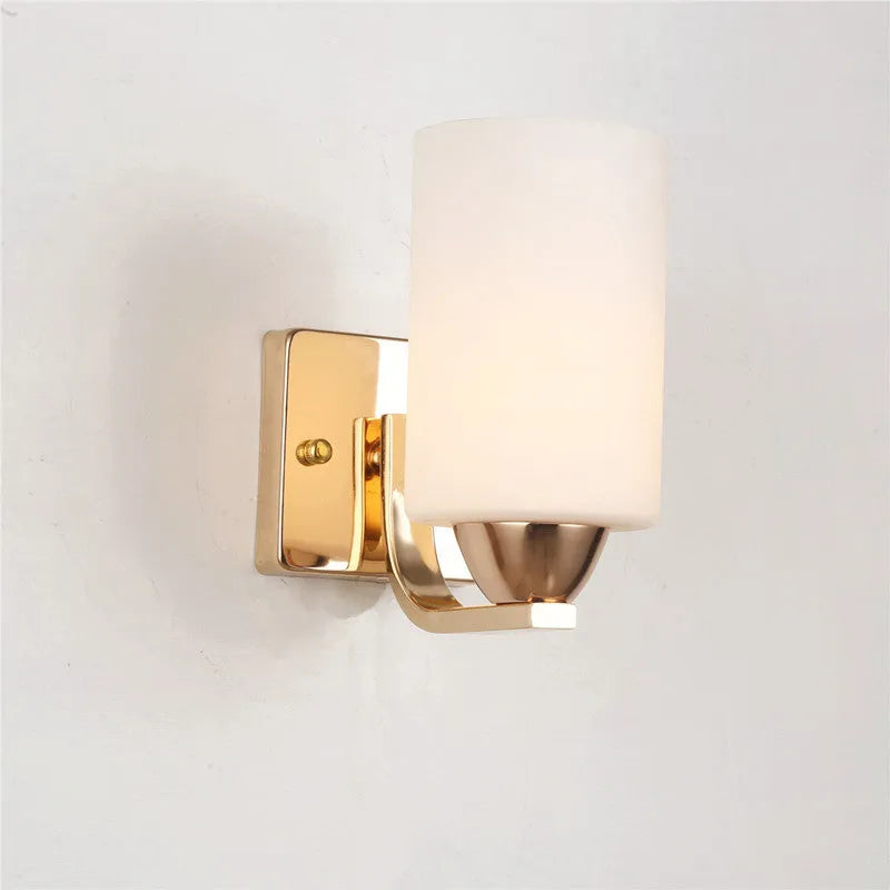 Minimalist chrome-finished glass wall lamp with single head configuration on white wall