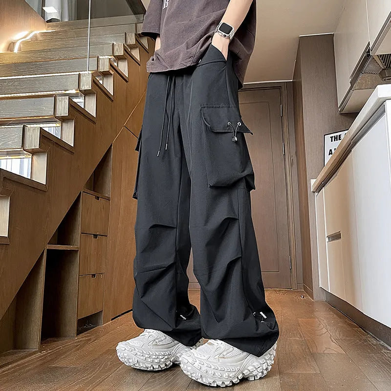 Black waterproof plus size loose fit straight-leg trousers with a drawstring waist.