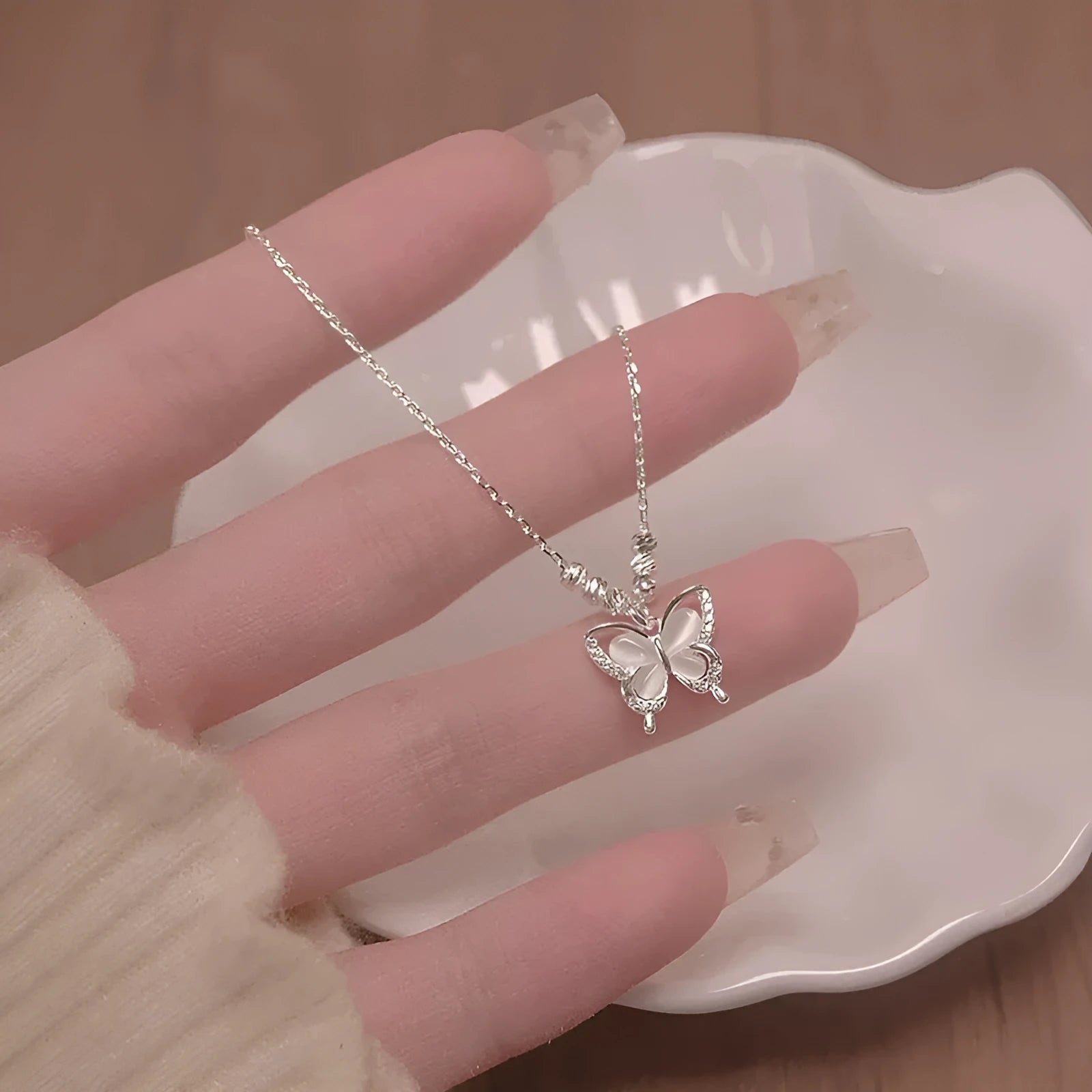 Women's silver butterfly necklace with 925 silver pendant and adjustable cross chain showing opal detail