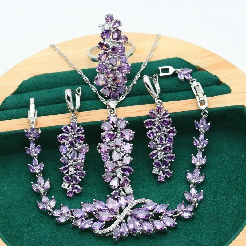Retro floral pattern jewellery set with necklace, earrings, ring, and bracelet in olive or purple colours