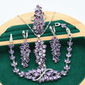 Retro floral pattern jewellery set with necklace, earrings, ring, and bracelet in olive or purple colours