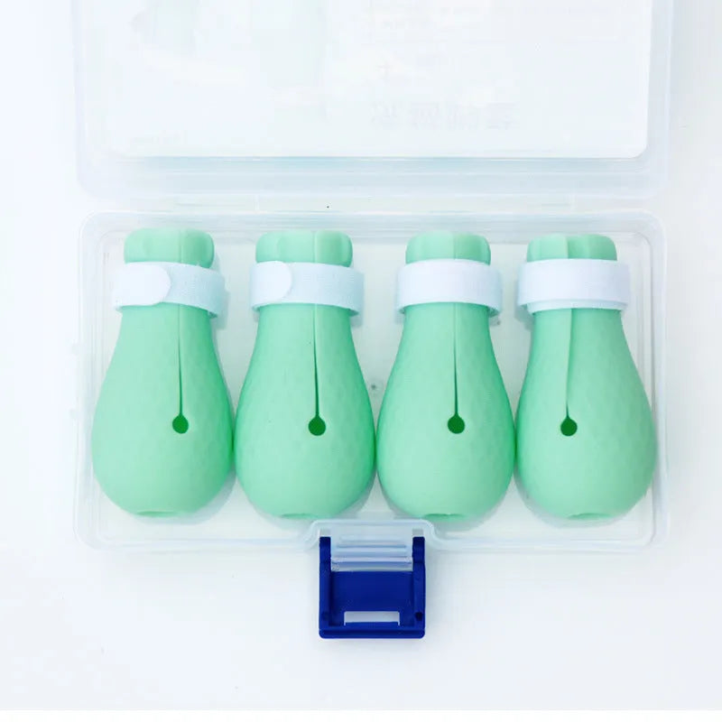 Four green silicone cat anti-scratch foot covers for paw protection during washing and handling