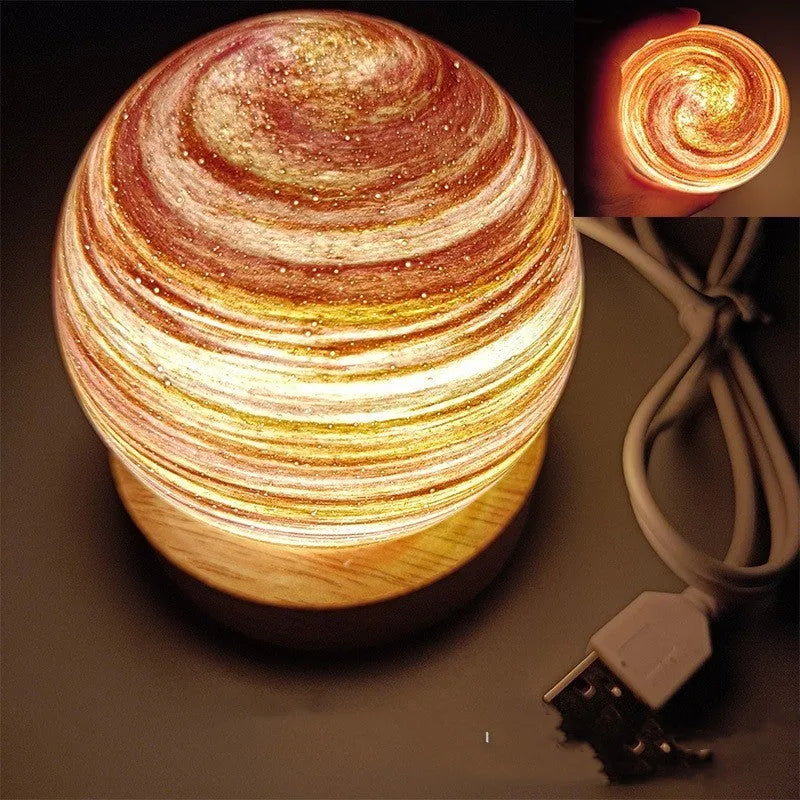 Planet night light with USB cable and base in modern simple design showing spherical shape