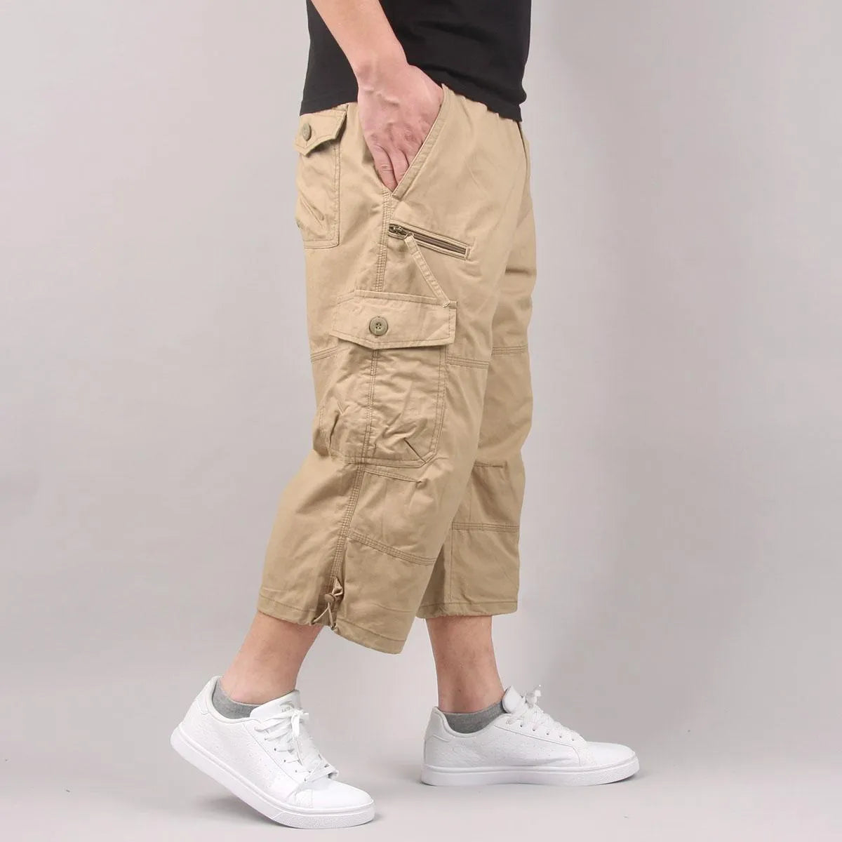Men's loose fit cotton cropped pants in army green colour, shown on a hanger.