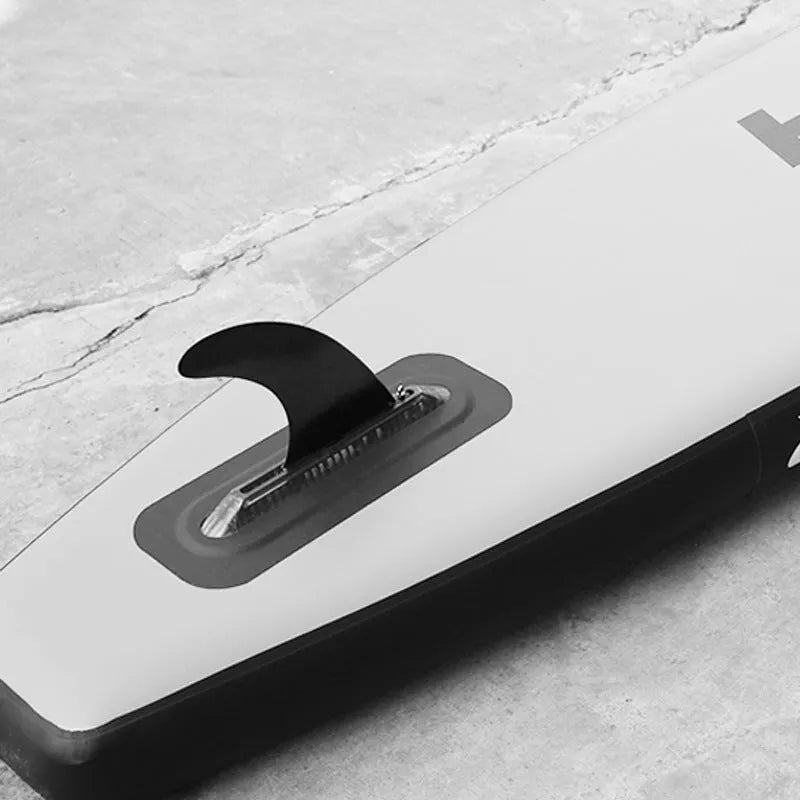 SUP paddle with large removable plastic fish fins attached, shown as a paddleboard accessory.