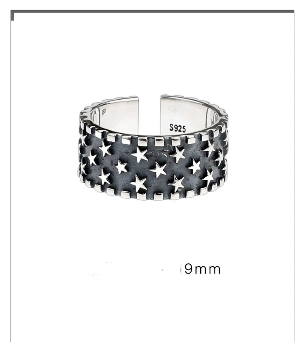 Adjustable sterling silver ring with a geometric five-pointed star pattern on a plain background.