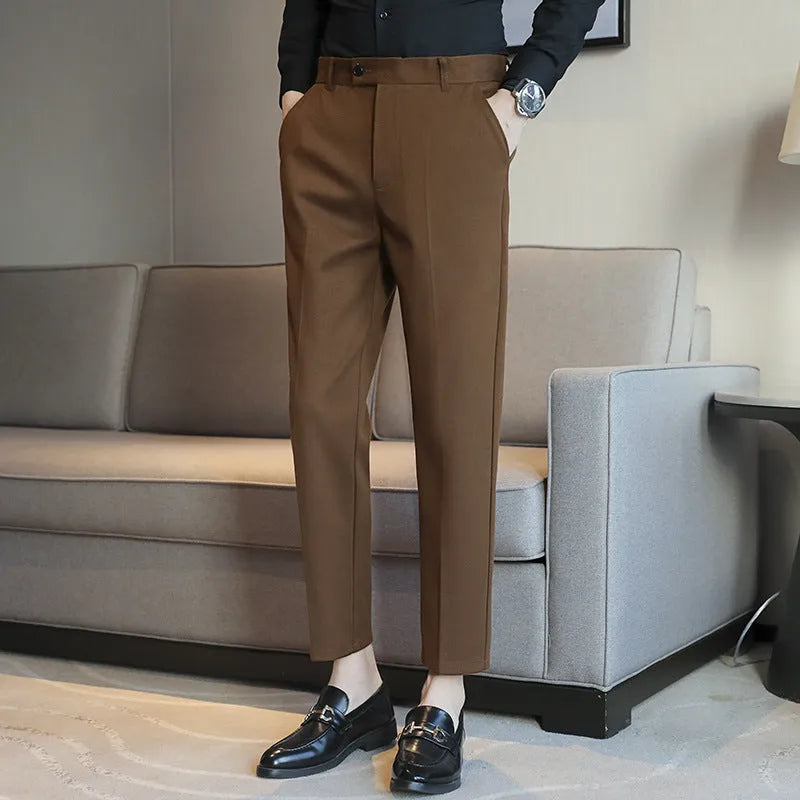 Retro brown straight leg corduroy trousers with elastic waistband laid flat.