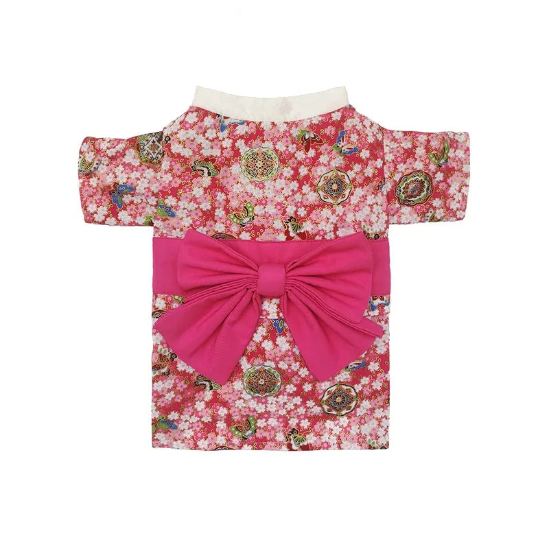 Small dog wearing a cherry blossom print kimono-style pet clothing in a standing pose