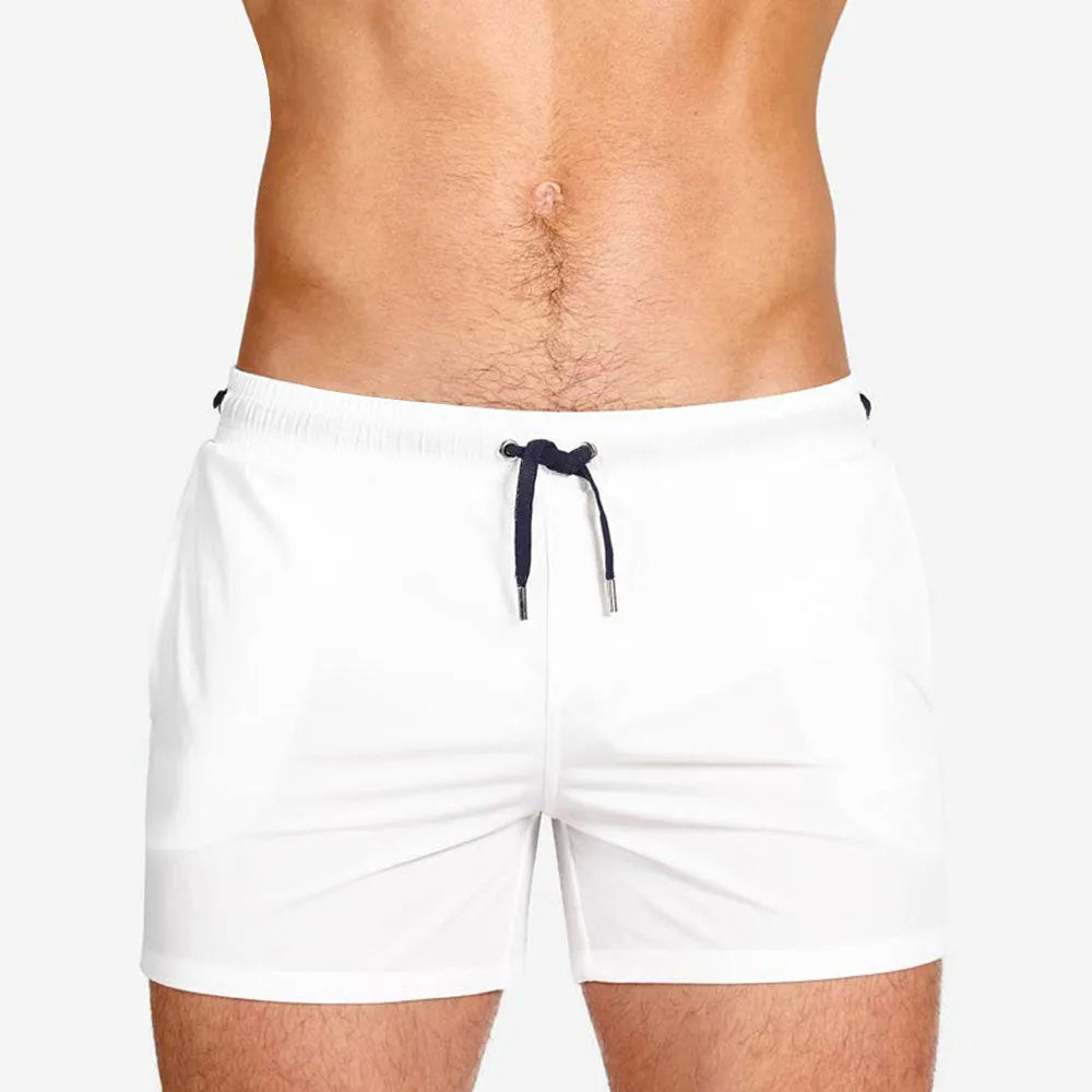 Men's solid colour mesh lining polyester sports shorts for swimming and fitness.
