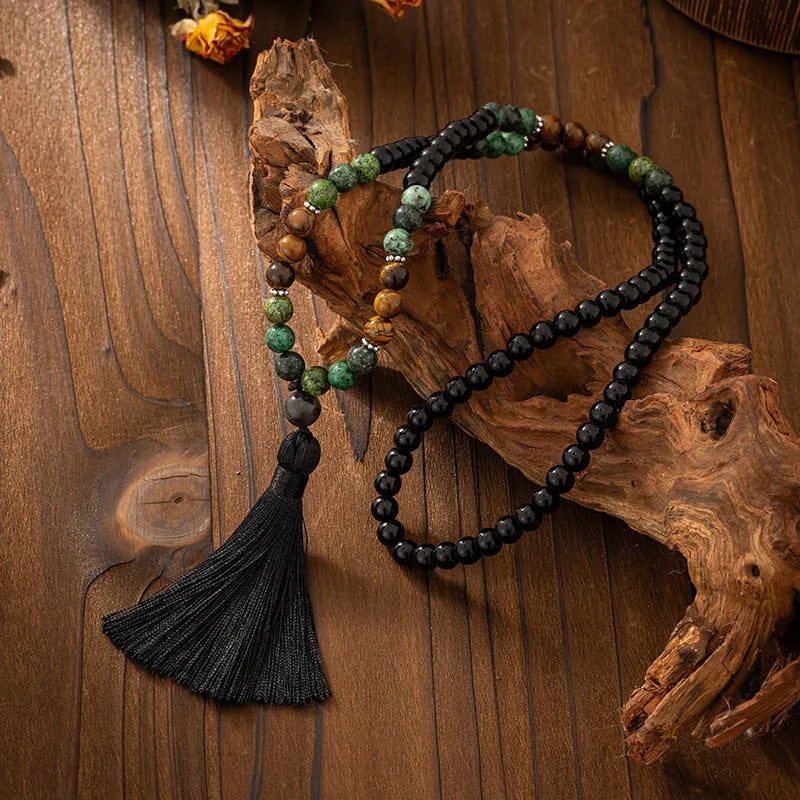 Vintage bohemian long necklace with geometric stone beads and tassel, shown with a matching shorter bracelet.