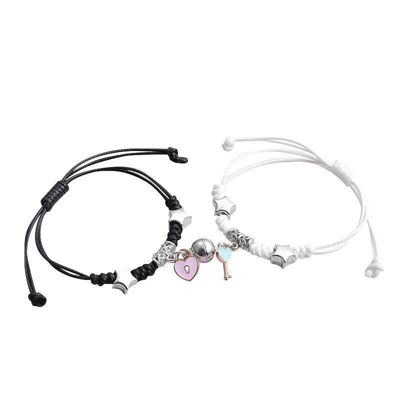 Pair of magnetic suction bracelets with alloy charms in various love and friendship themed designs on a wrist.