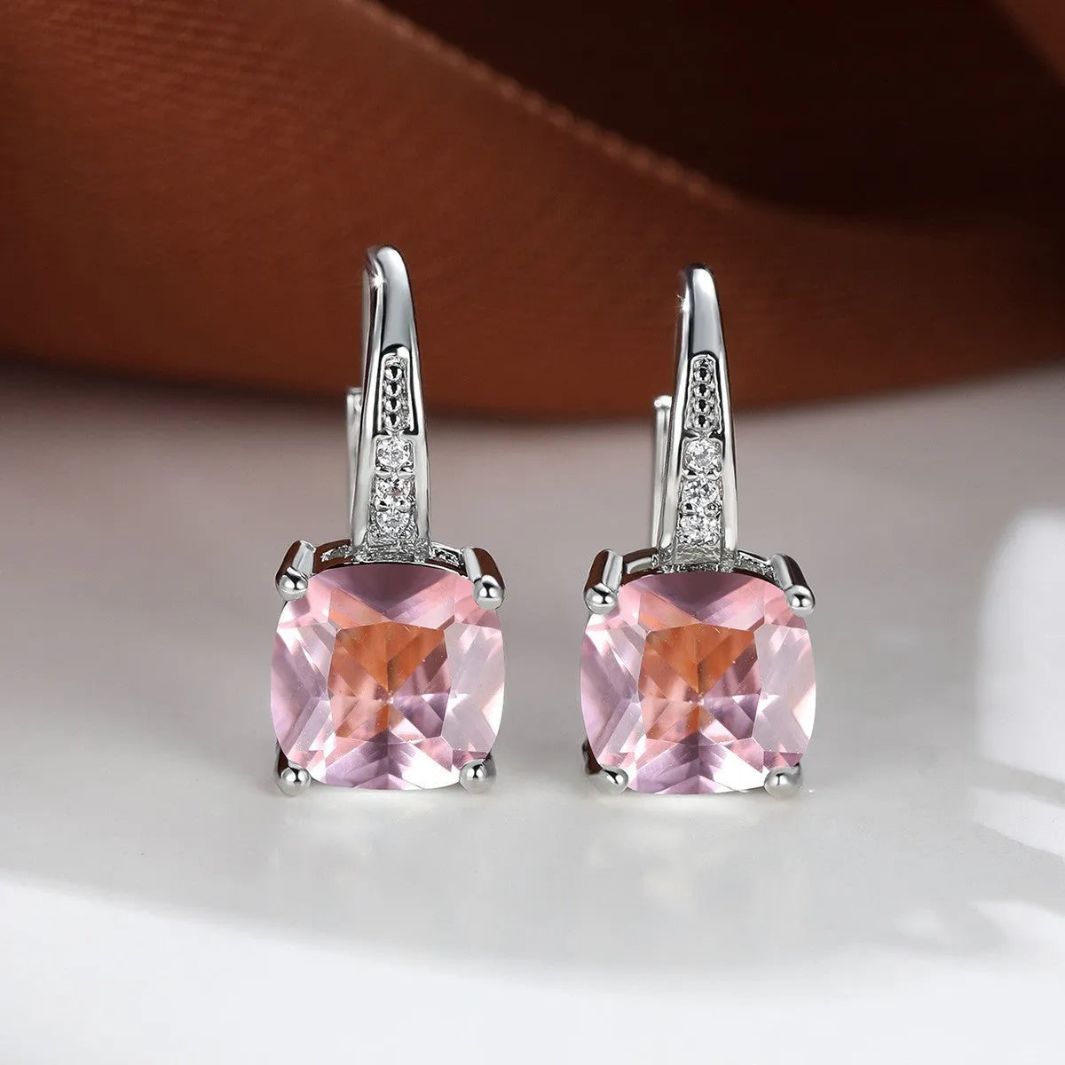 Square geometric ear hook studs with a round zircon stone, shown in a gold electroplated finish.