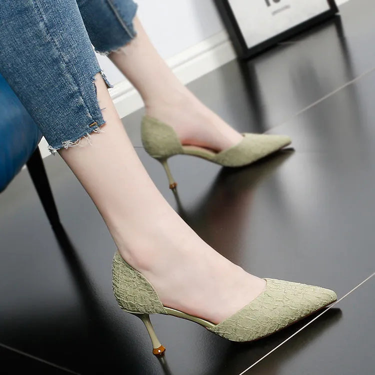 Women's black pointed toe stiletto high heels with PU leather upper on a plain background.