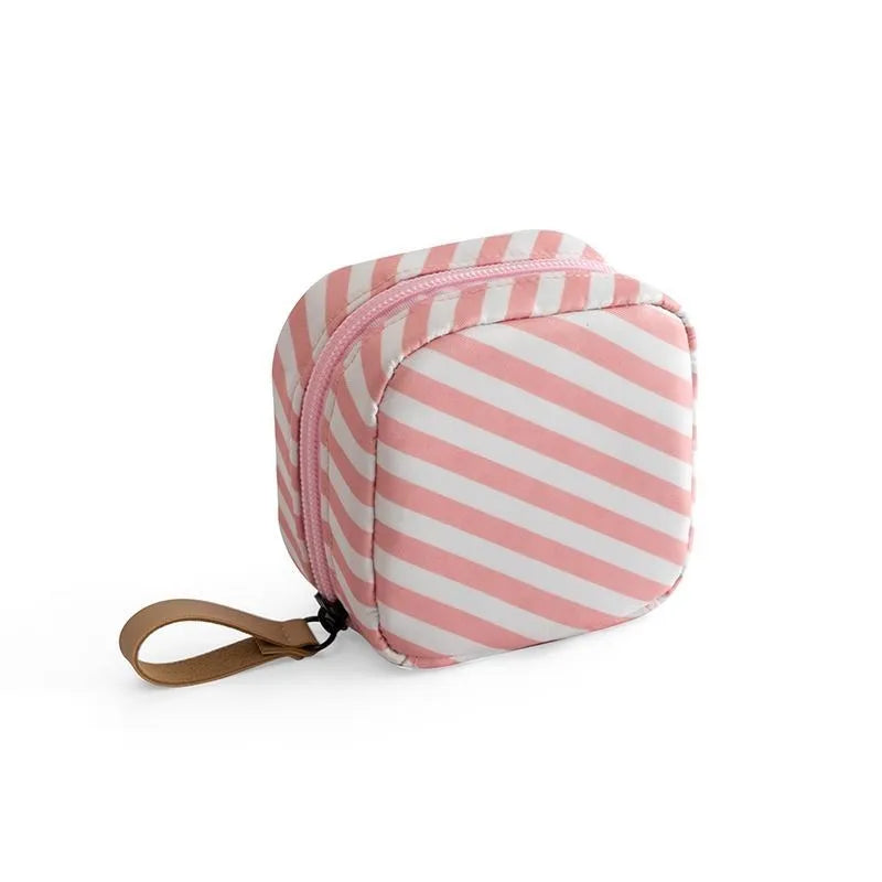 Cloth fabric cube-shaped makeup storage bag in blue, pink, white, and pink/white colour options.