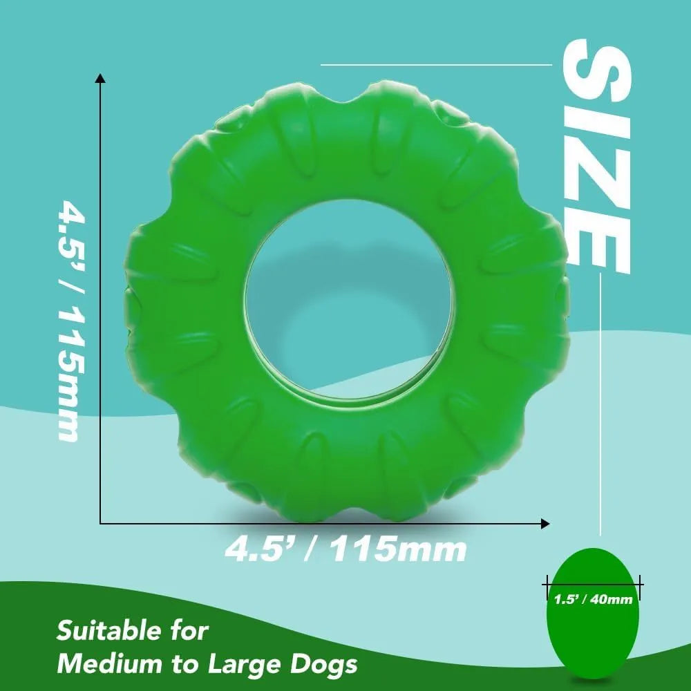 Blue tyre-shaped dog chew toy with oval openings for treat dispensing on a wooden floor.