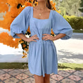 A child's orange puff sleeve dress with a square collar and backless design, featuring an A-line silhouette.