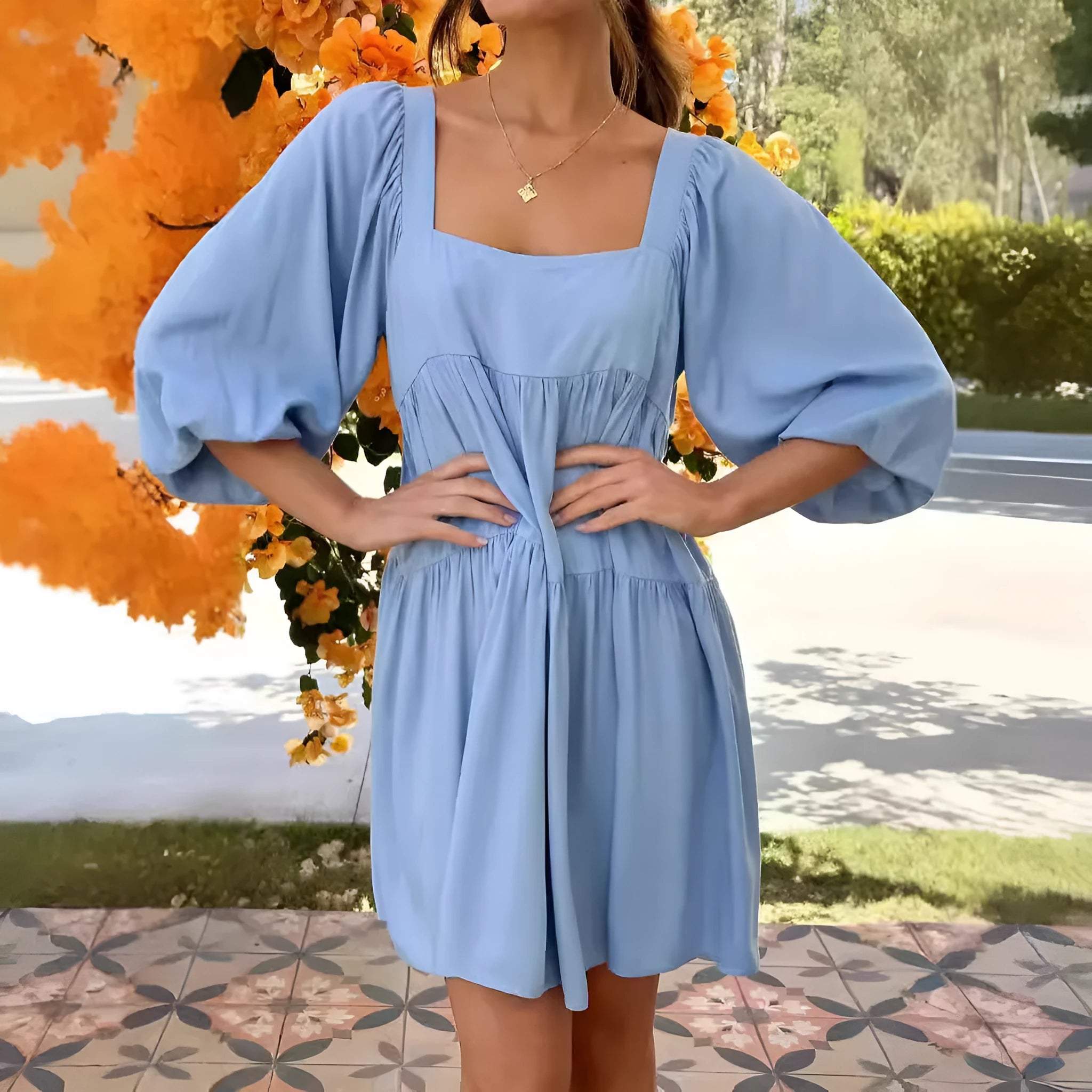 A child's orange puff sleeve dress with a square collar and backless design, featuring an A-line silhouette.