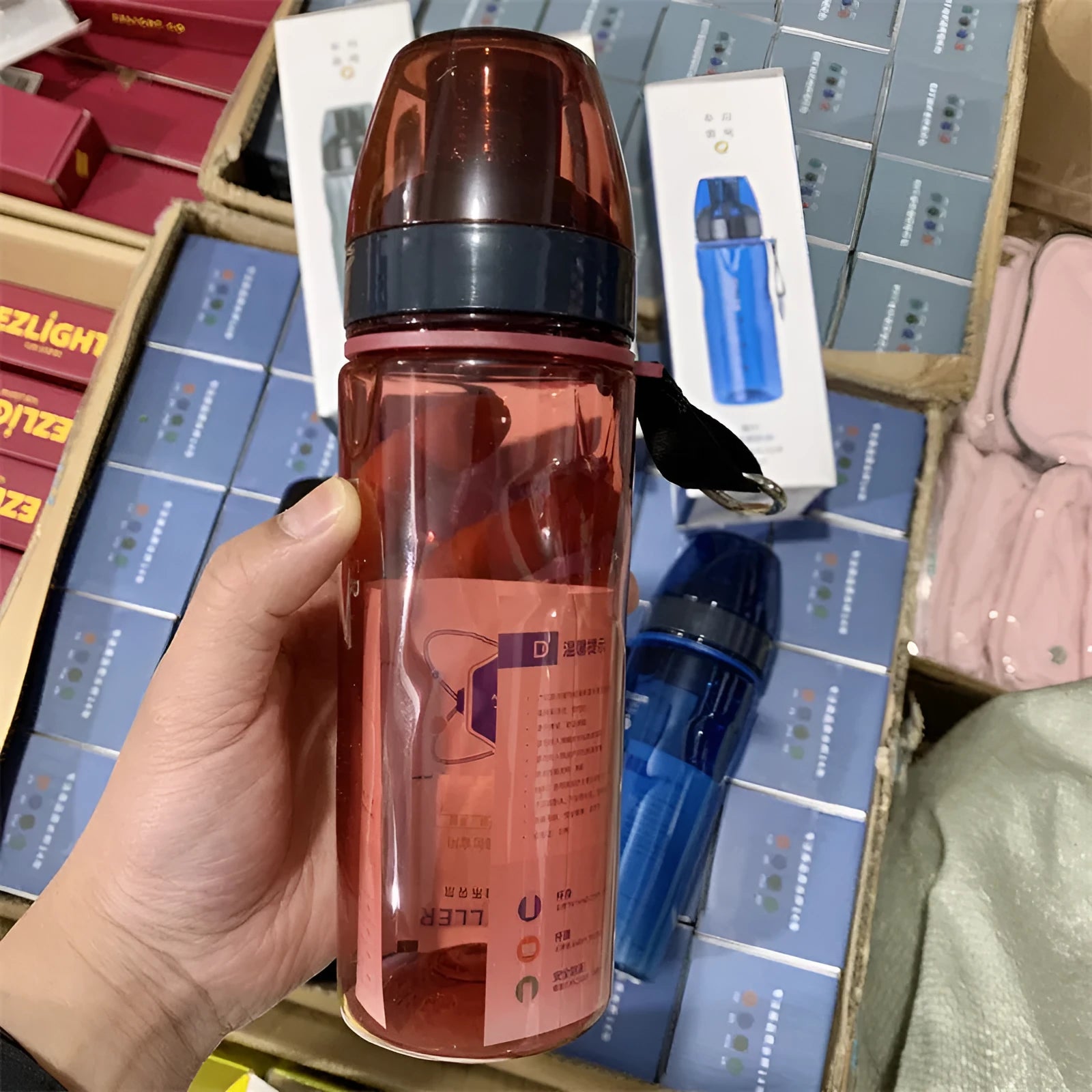 Chinese-style portable sports water bottle with tea infuser compartment in blue, red, black, or grey.