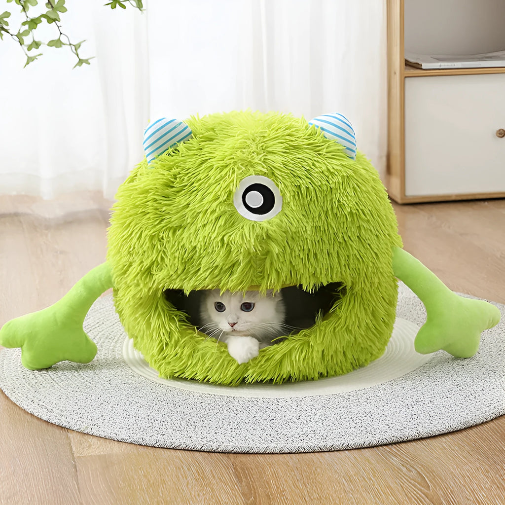 Round fluffy plush cat bed on a floor, showing its non-slip base, next to a resting cat.