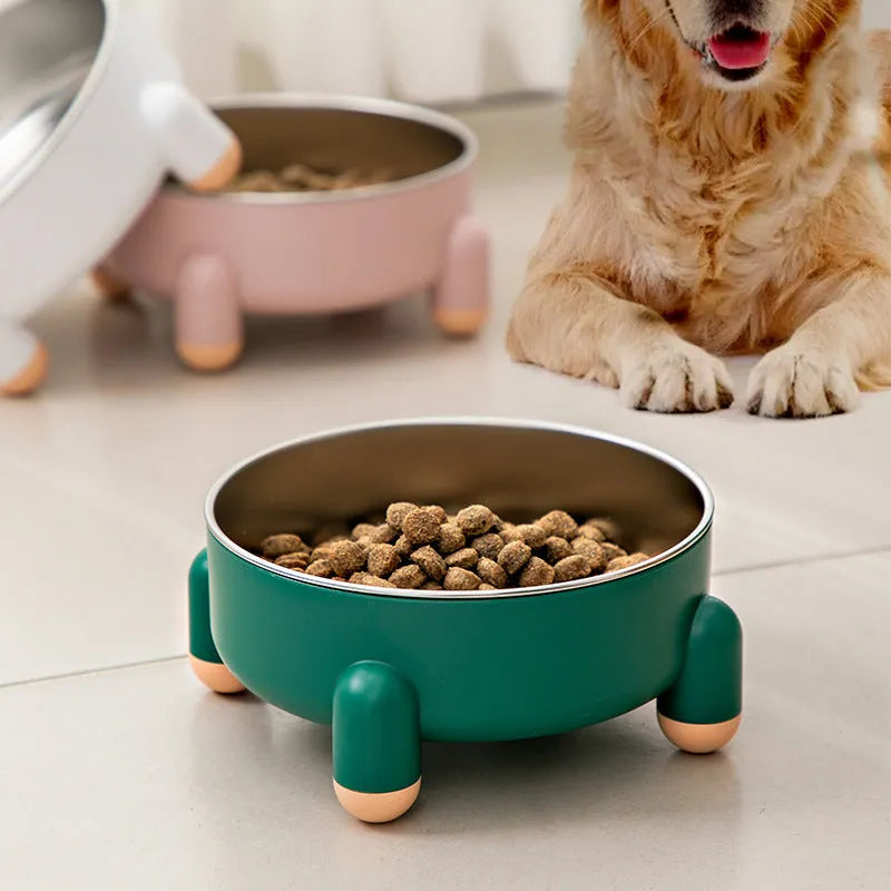 Green stainless steel pet bowl with a high foot and non-slip silicone base on a floor