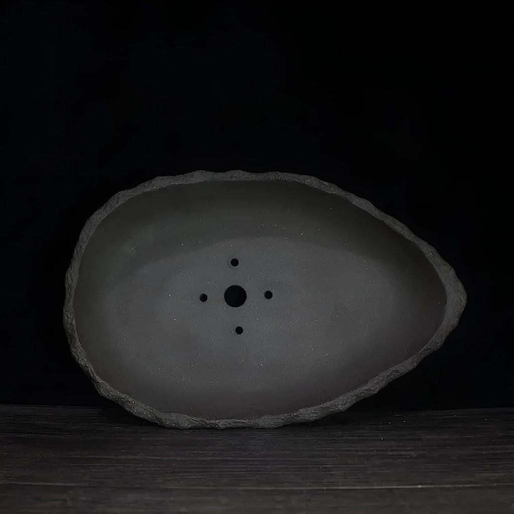 Handmade purple clay flower pot in various sizes and styles for indoor plants.