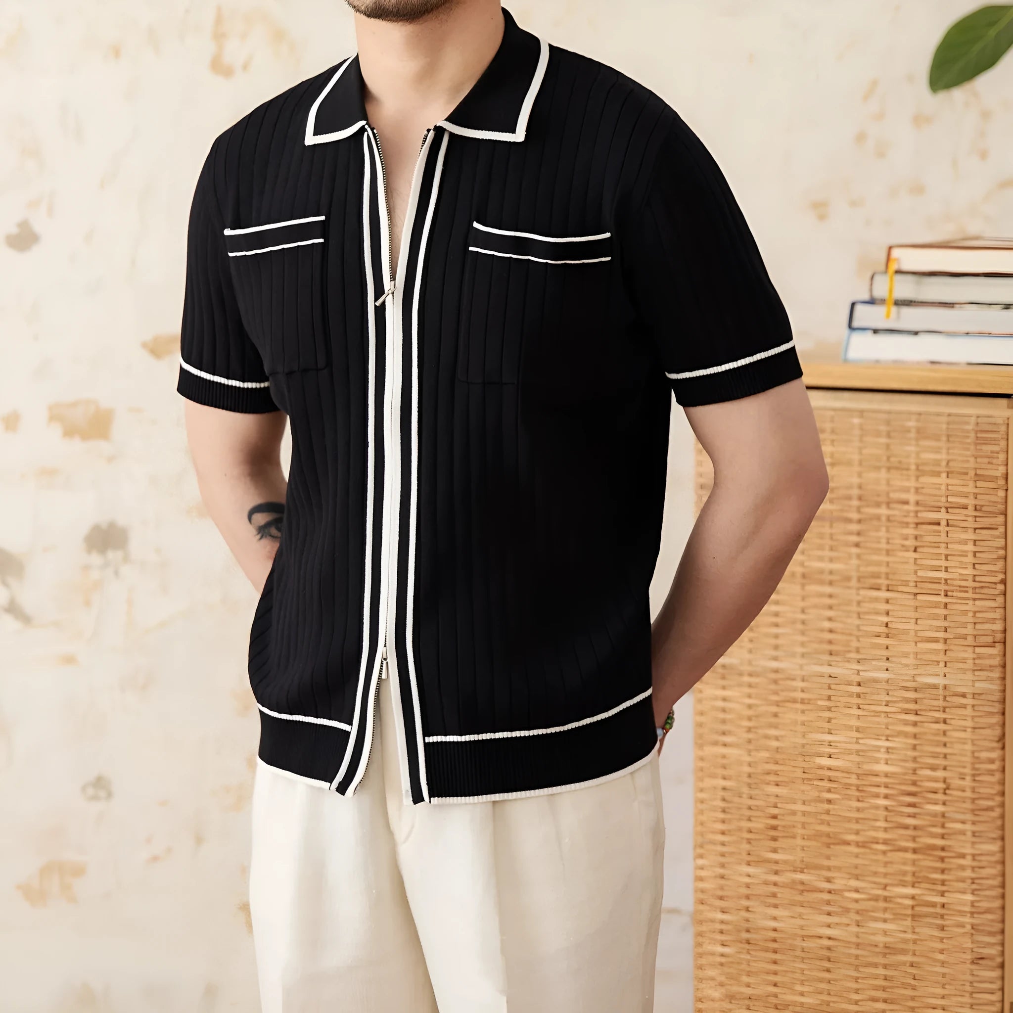 Slim-fit man's knitted polo shirt with a lapel collar and short sleeves in a black viscose blend fabric.