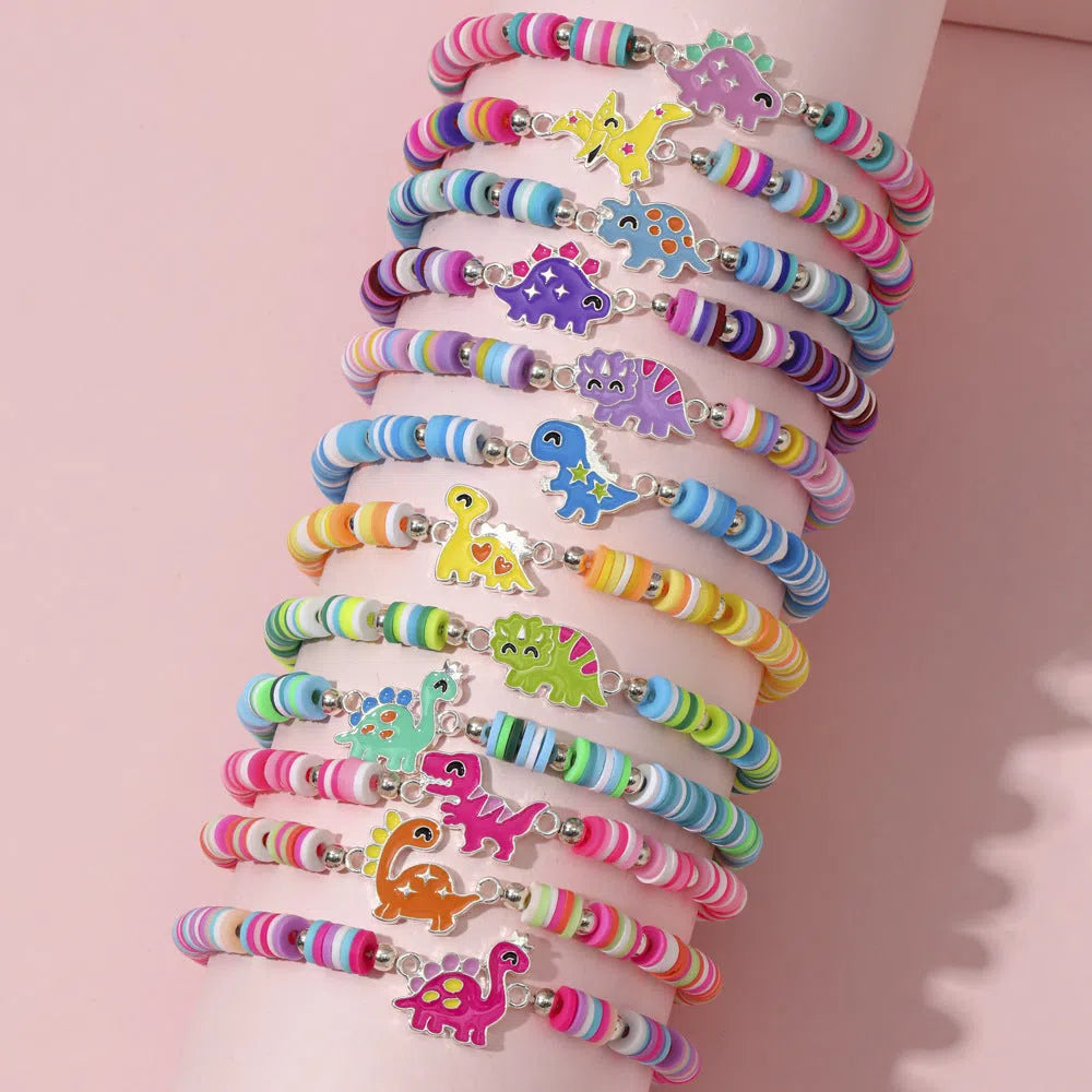 Children's polymer clay bracelet with dinosaur bead theme on a white background
