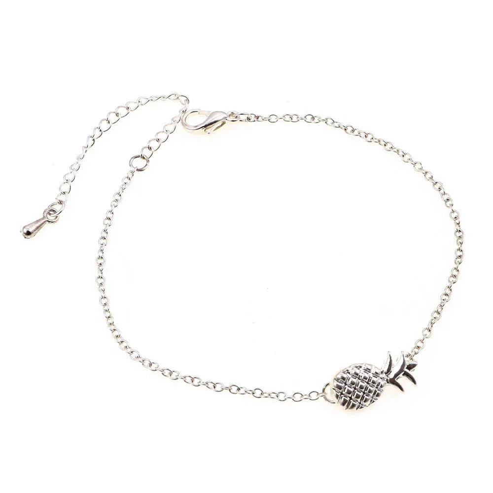 Women's alloy bracelet featuring a central pineapple charm in gold or silver colour.