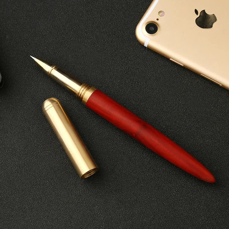 Brass and sandalwood solid wood signature pen with wooden barrel and brass fittings on a desk