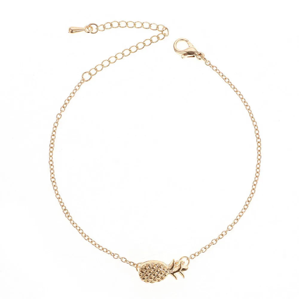 Women's alloy bracelet featuring a central pineapple charm in gold or silver colour.