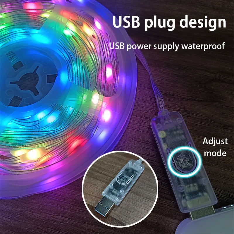 10 metre long multicolour LED party light string with 100 lights coiled on a table next to its control switch.