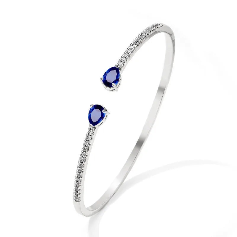 Copper bracelet with multi-zircon inlay in simple style, shown in white and blue colour options.