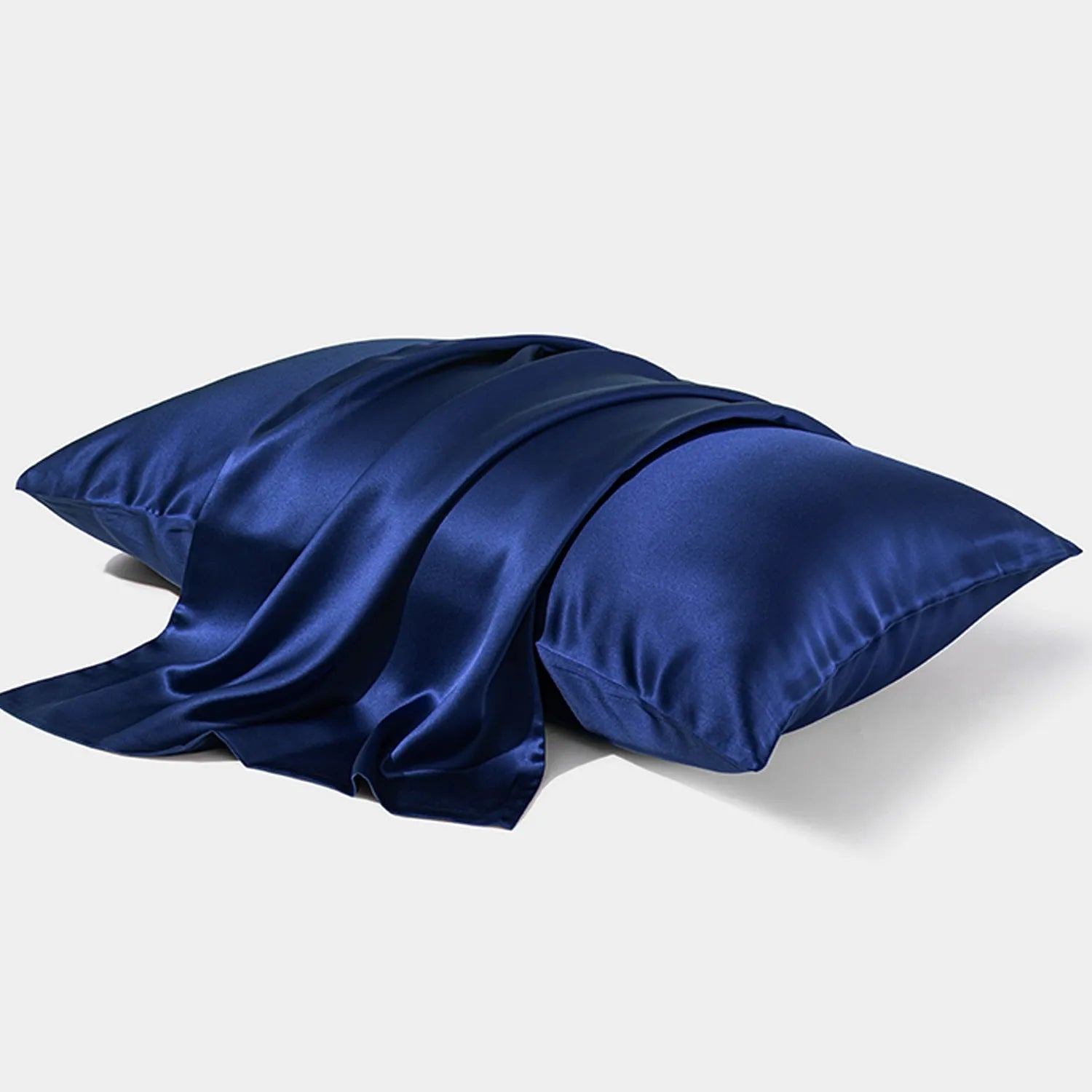 Solid colour mulberry silk envelope pillowcase in dark grey on a bed.