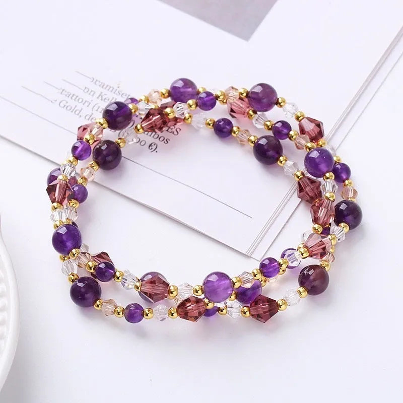 Women's adjustable three-ring bracelet with colourful tourmaline, strawberry quartz, and amethyst crystals on a cord.