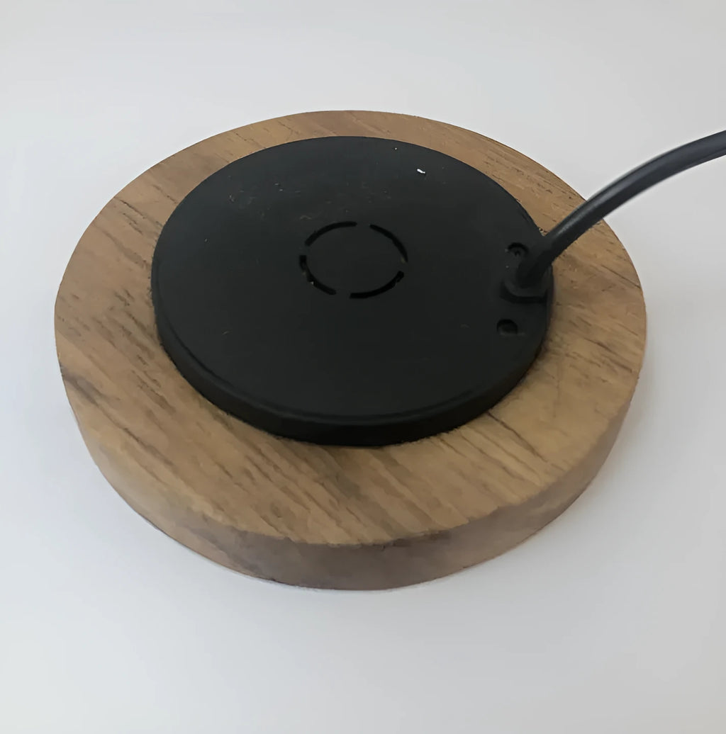Round 60mm hidden wireless phone charger for installation in furniture.
