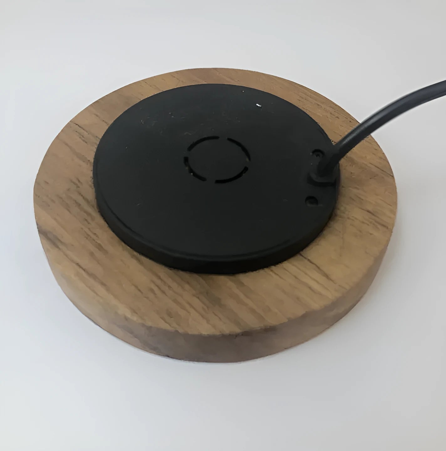 Round 60mm hidden wireless phone charger for installation in furniture.