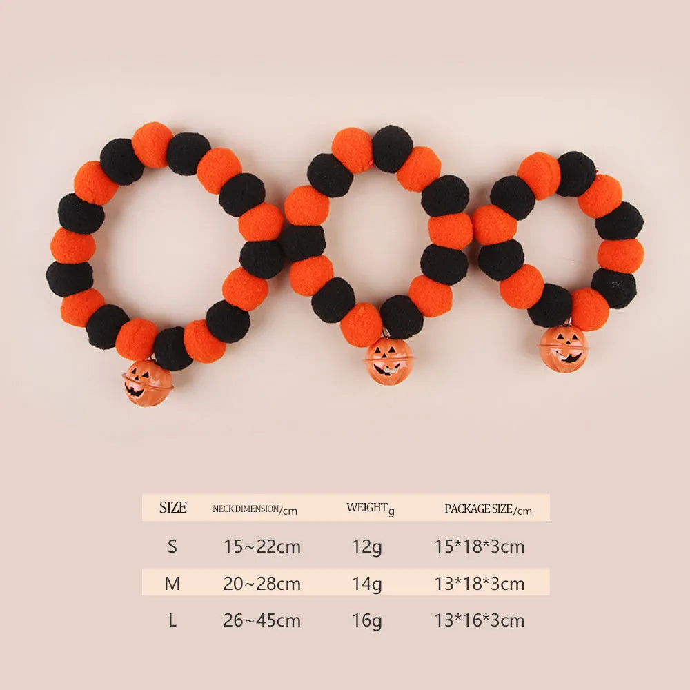 Orange Halloween cat collar with 'Naughty Cat' text and a detachable plastic pumpkin charm on a table.