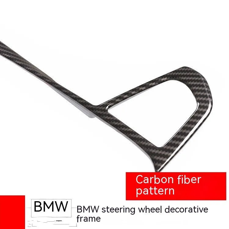 BMW steering wheel button frame decorative trim in black carbon fibre pattern.