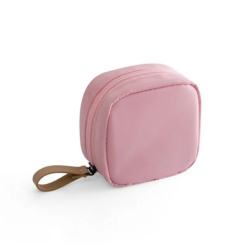 Cloth fabric cube-shaped makeup storage bag in blue, pink, white, and pink/white colour options.