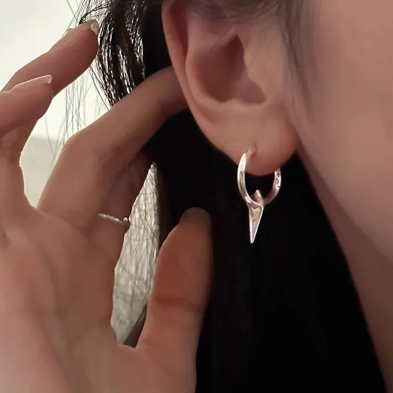 A pair of gold and white electroplated geometric star ear clips made from solid copper for women.