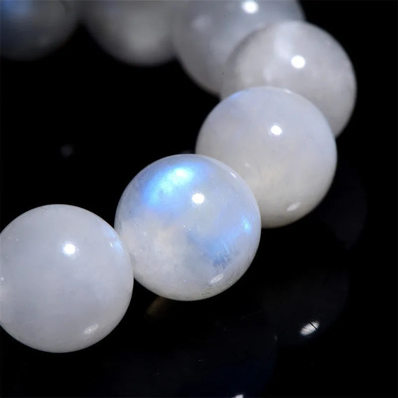 Natural blue moonlight round bead moonstone bracelet on wrist showing polished gemstone beads