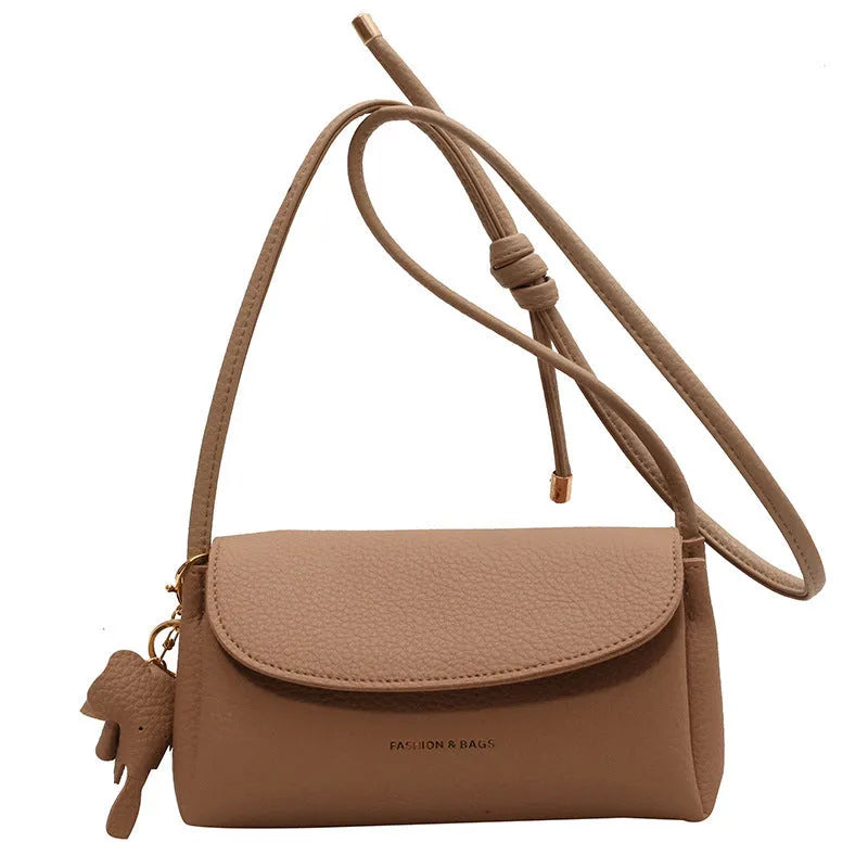Soft PU small shoulder bag in khaki with pillow silhouette and sewing thread detail, 21cm wide.
