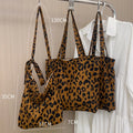 Length adjustable canvas shoulder bag in vintage leopard print with zipper closure