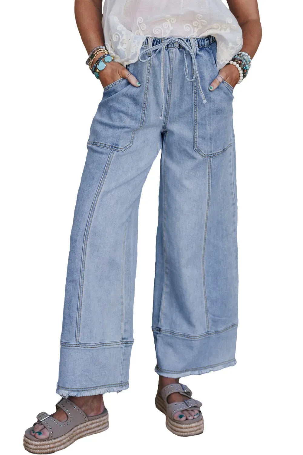 Beau blue wide leg denim trousers with drawstring waist and raw hem detail laid flat
