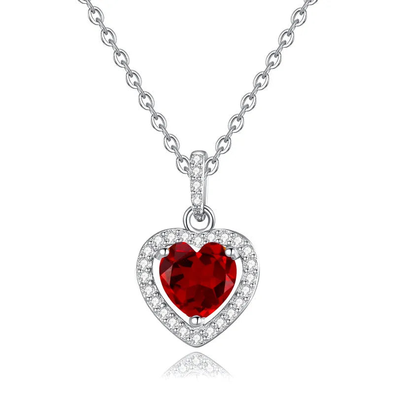 Sterling silver heart pendant necklace with a natural coloured gemstone on an adjustable cross chain.