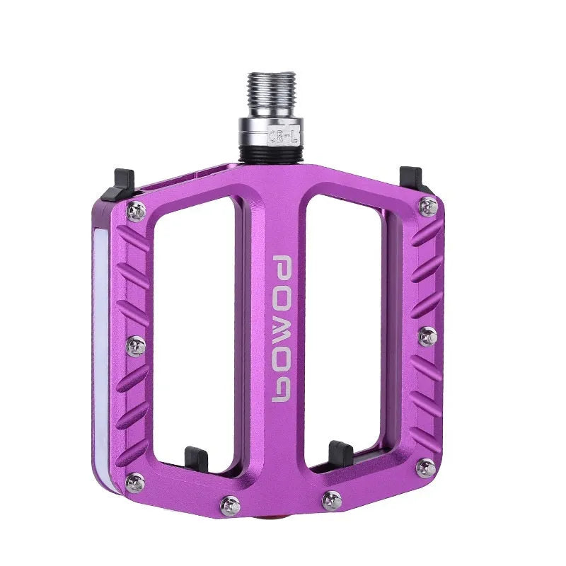 Bicycle pedals with LED lights in purple, black, titanium, red, and gold colour options